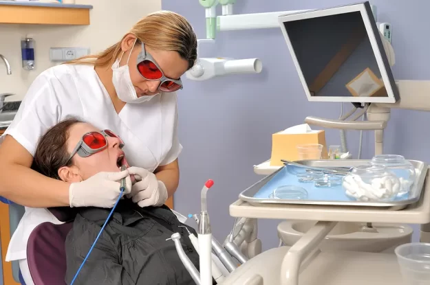 Hygienist is working on patient's teeth in Tigard