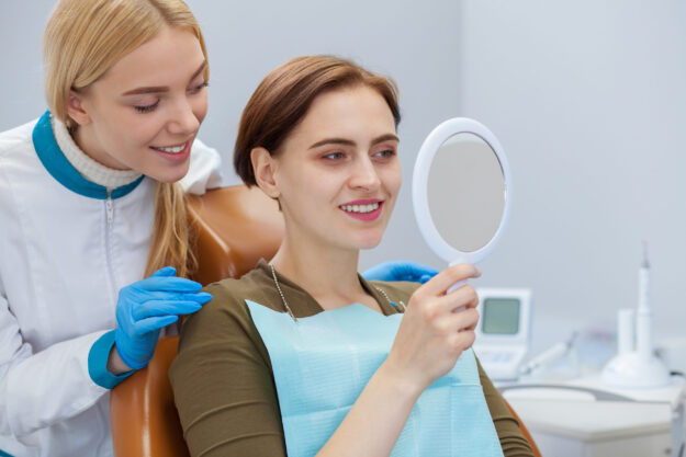 Dental assistant consulting patient