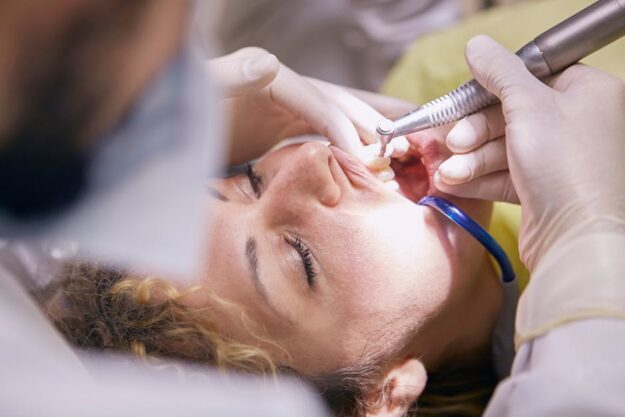 Dentist is working on patient's tooth